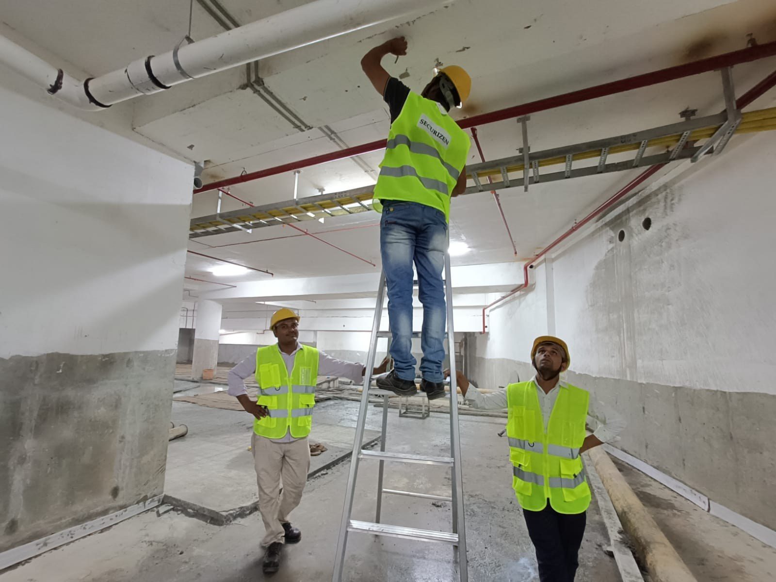 Securizen engineers on site, fixing a camera in a basement car park